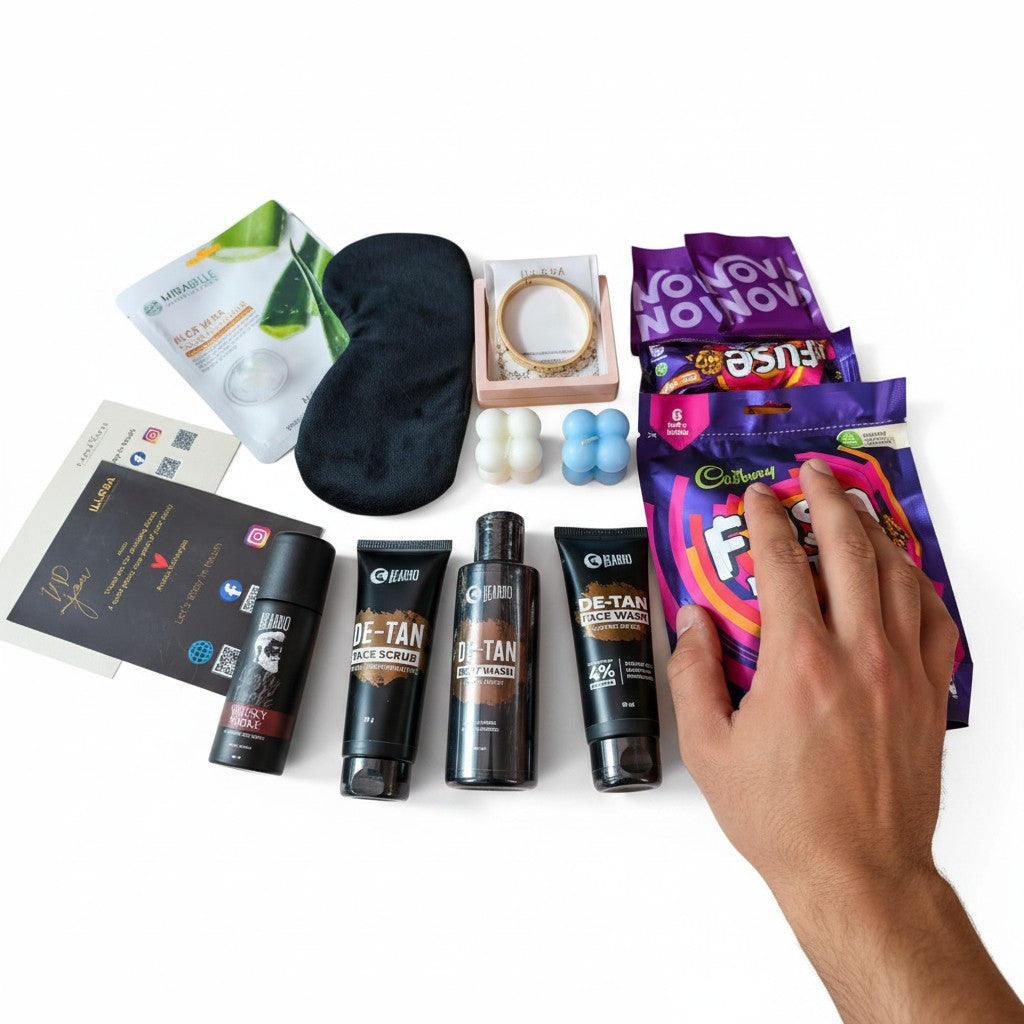 Close up of The Tidal Gentleman Grooming & Self-Care Gift Hamper For Men containing De-tan kit, sweet treats and jewellery