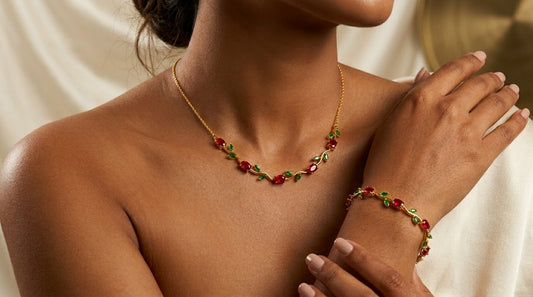 Women wearing Tulip Necklace & Bracelet Set with Red & Green stones against a neutral background