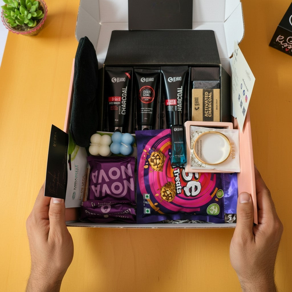 Hand holding an open box of Grooming & Self-Care hamper for him