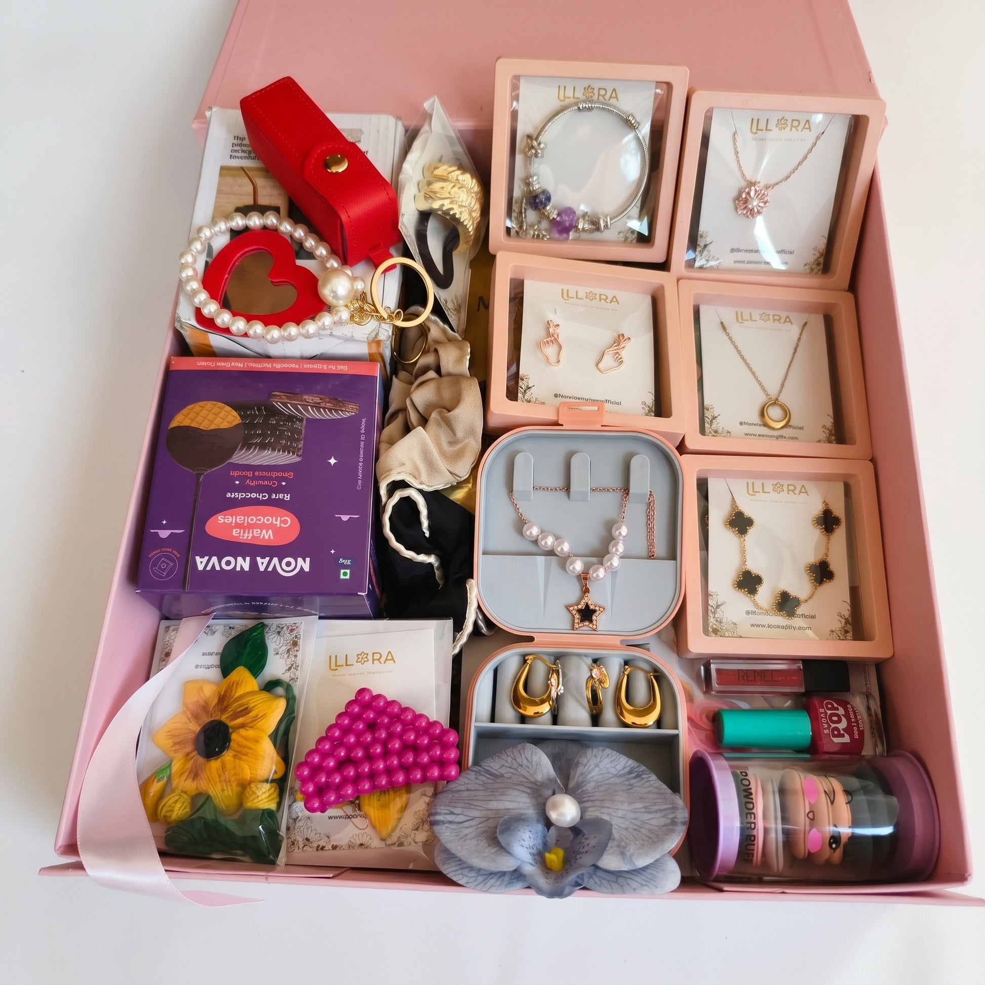 Close-up of Gift Hamper for Her in a luxury hamper box filled with jewellery and beauty products on a white background