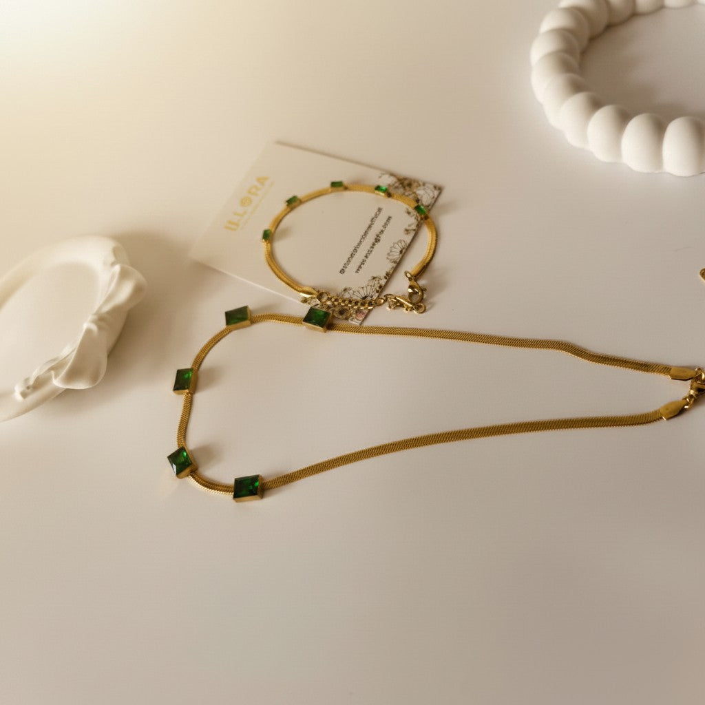 Gold-plated Green Emerald Stone Embedded Snake Necklace & Snake Bracelet Set on a white surface
