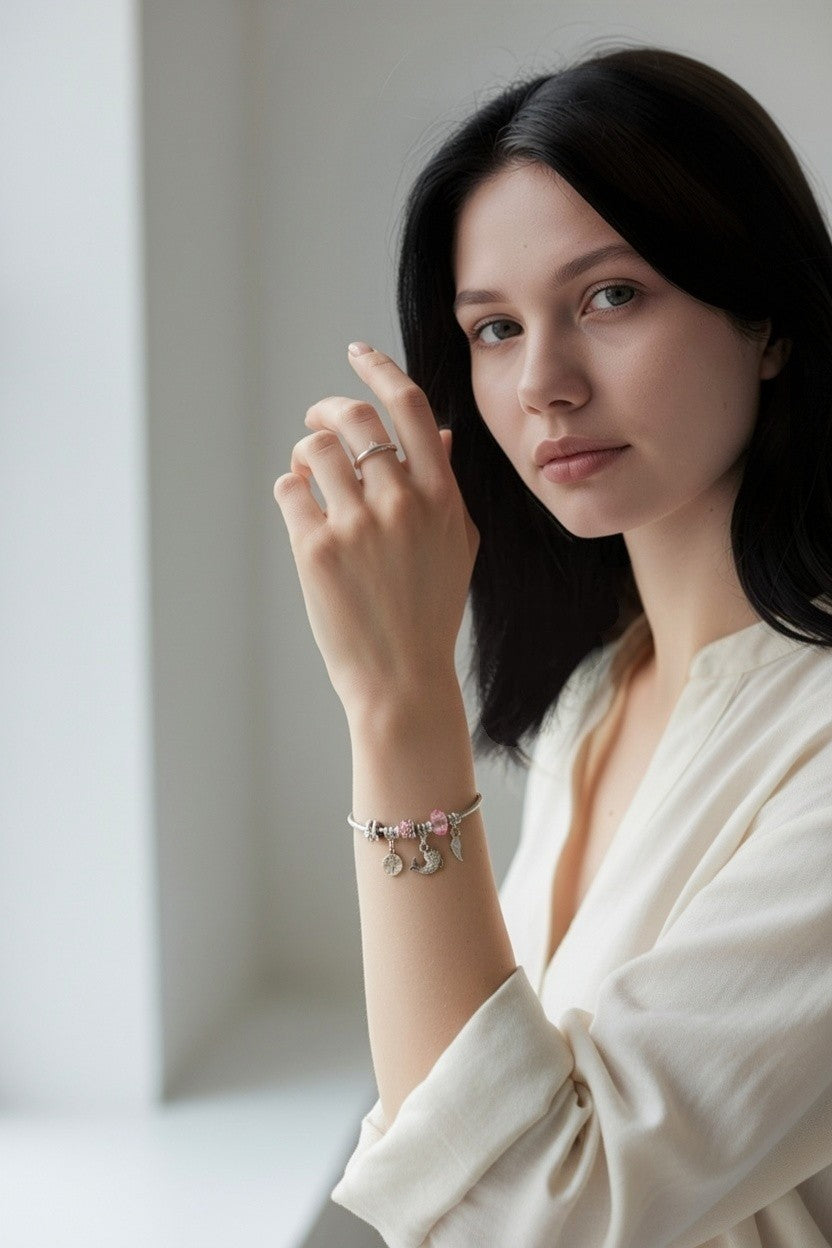 Woman wearing Chic Hug Charm Set – Anti-tarnish Silver-plated Charm Bracelet & Hug Ring against a neutral background