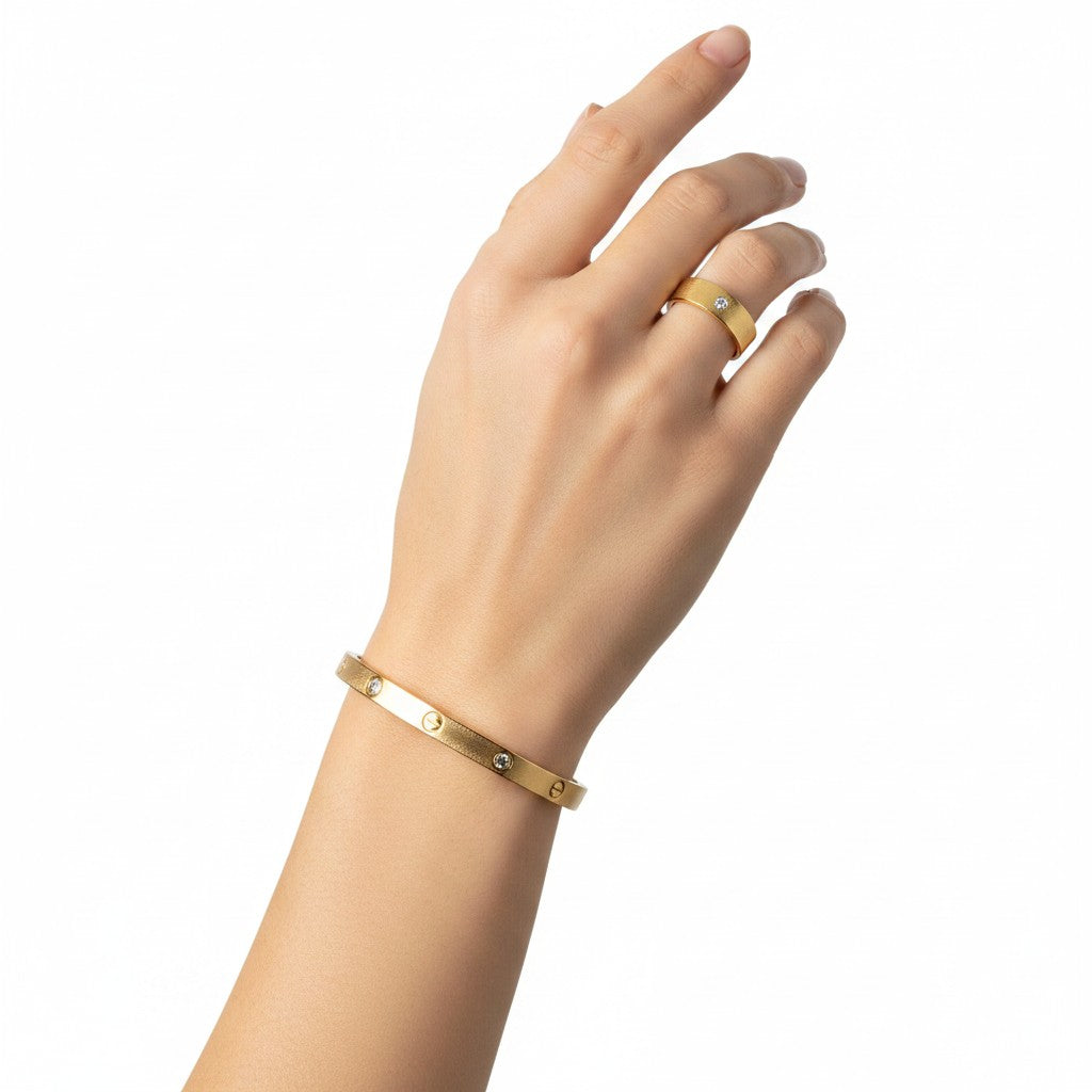 Hand wearing Classic Zircon Kada Duo – Anti-tarnish 18k Gold-plated Zirconia Kada Bracelet & Kada Ring on a white background
