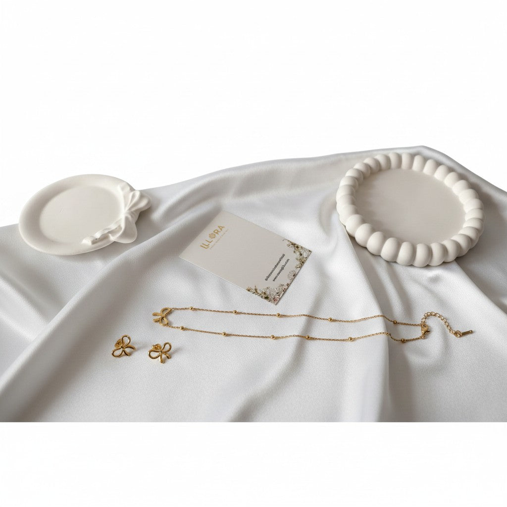 Anti-tarnish 18k Gold-plated Bow Chain Pendant & Bow Ear Studs on a white fabric background.