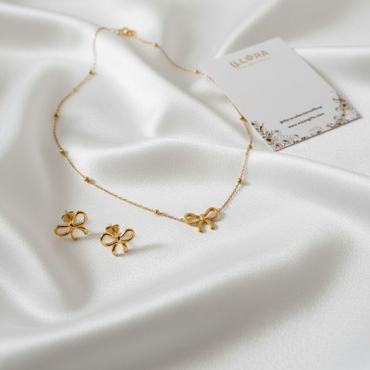 Sweet Bow Muse Duo – Anti-tarnish 18k Gold-plated Bow Chain Pendant & Bow Ear Studs on a white fabric background