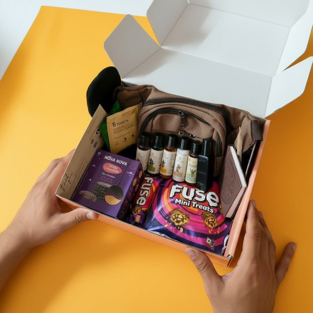 Hand holding the open mailer box containing The Urban Voyager Travel Care Gift Hamper For Men