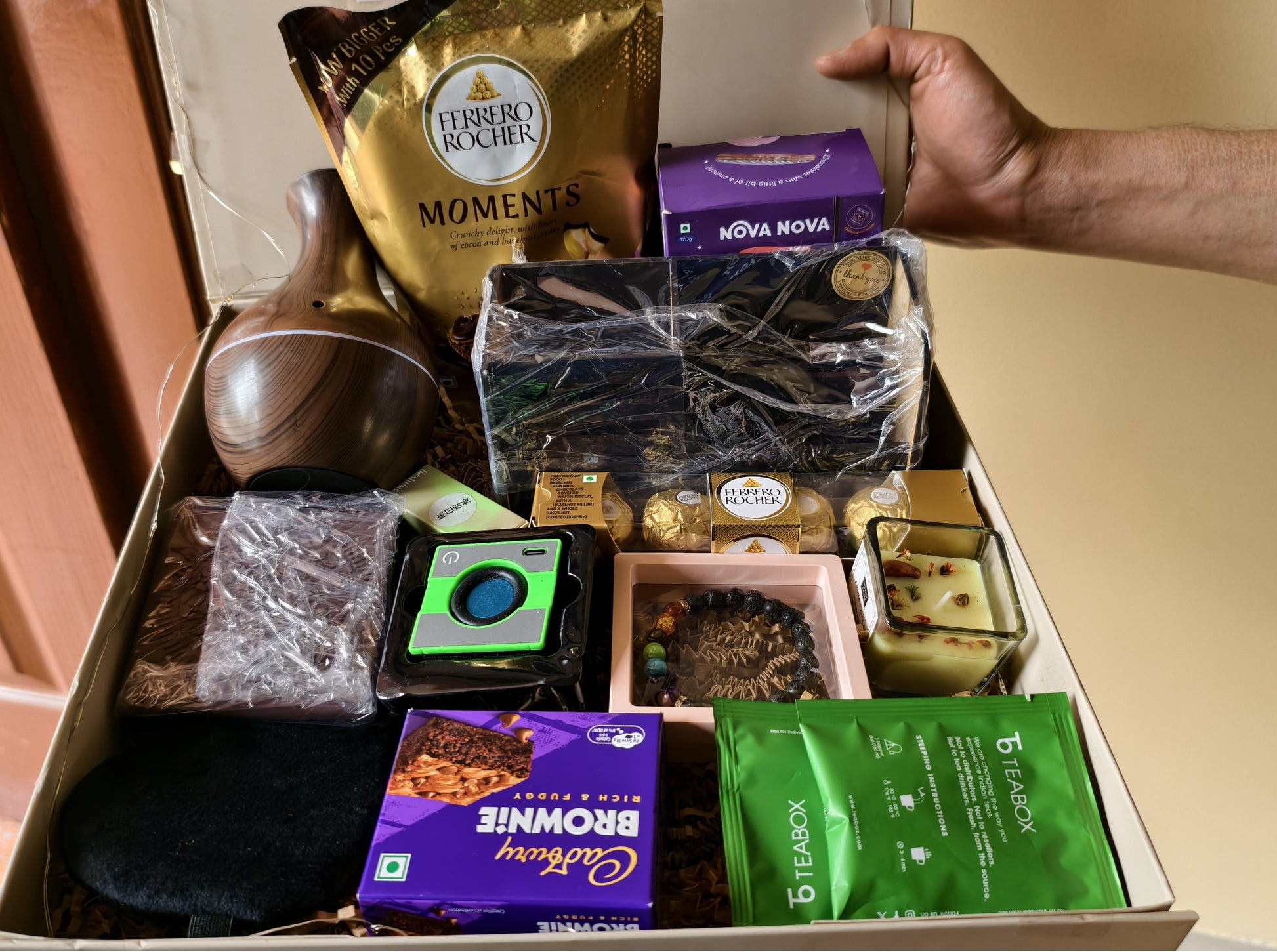 Hand holding Mindful Momentum Wellness & Productivity Gift Hamper for Men