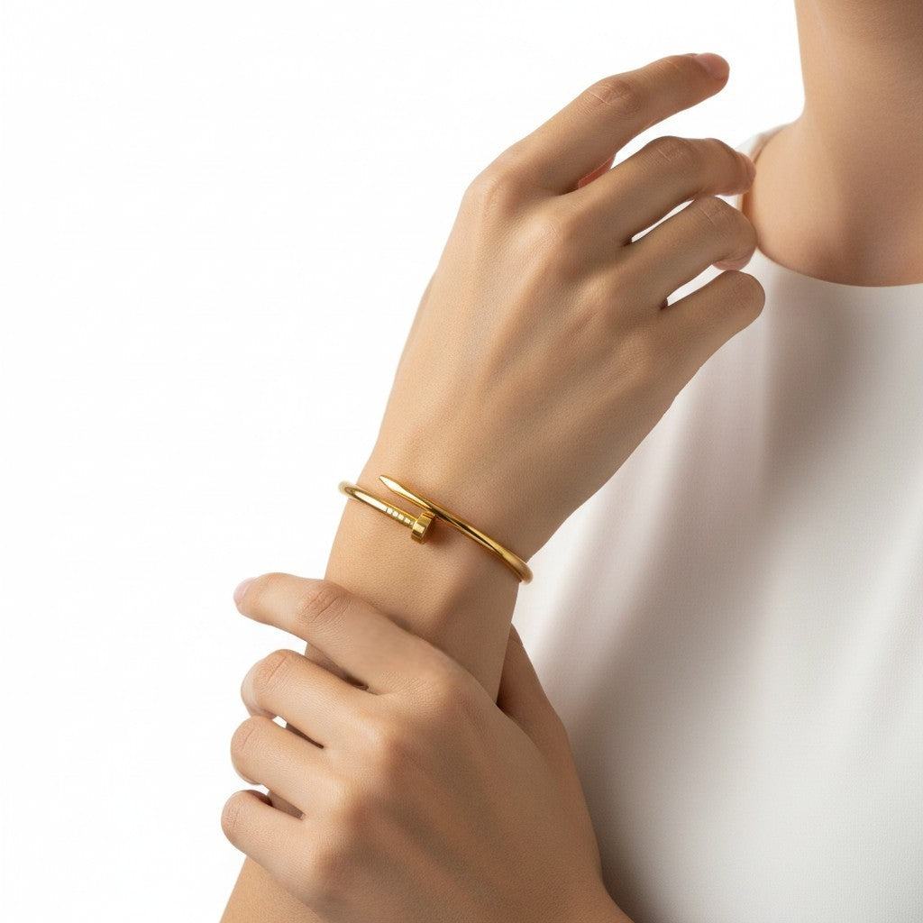 Anti-tarnish 18k Gold-plated Nail Bracelet on a wrist with a plain background