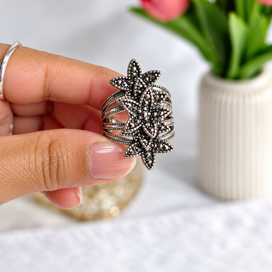 vertical view of Oxidised Black & Silver Polished AD Floral Chunky Statement Ring for Women 