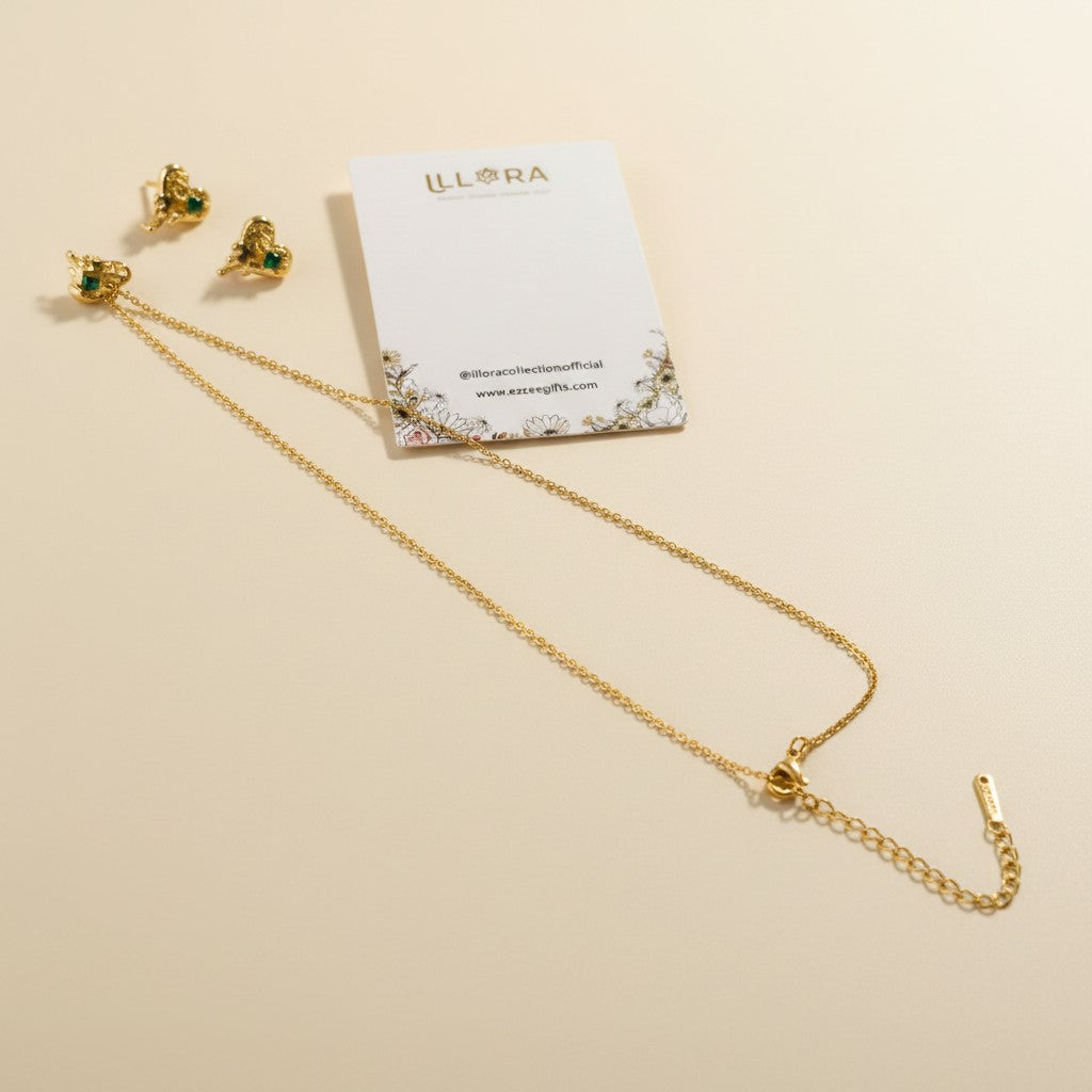 Gold-plated Melted Heart Pendant & Earrings Set with Emerald stone on a beige background