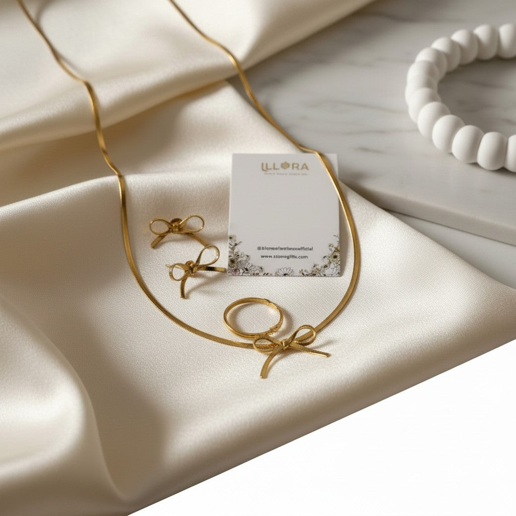 Anti-tarnish, Gold-plated Bow Necklace & Earrings Set on a white fabric background