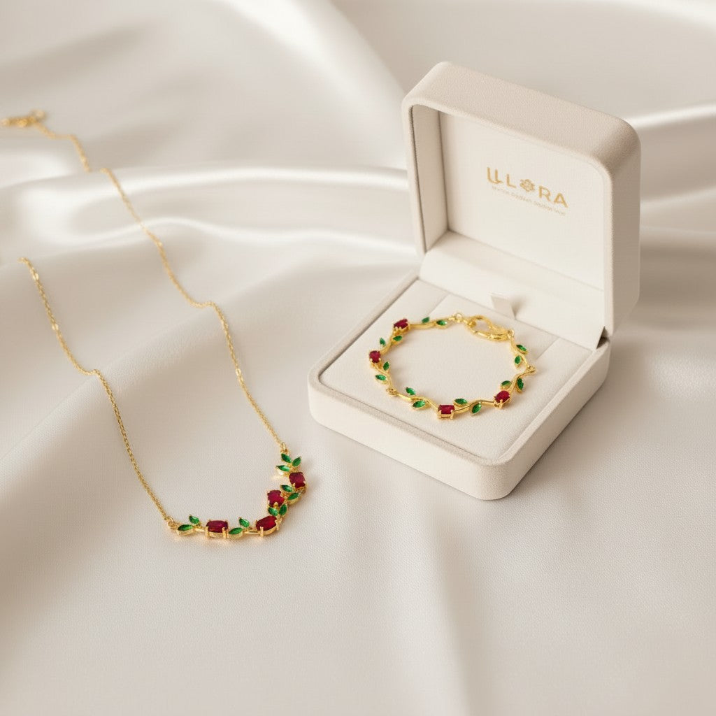 Scarlet Bloom Tulip Gold Plated Anti-Tarnish Jewellery Set for Women containing Red & Green Tulip Necklace & Bracelet on a white fabric background