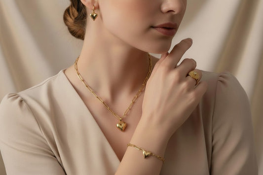 Woman wearing Golden Amour Heart Gold Plated Anti-Tarnish 4-Piece Jewellery Set with 1 Big Full Heart Ring against a neutral background.
