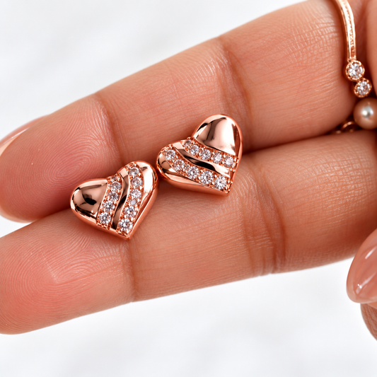 hand holding Rose Gold Plated Anti Tarnish American Diamond (AD) Minimal Heart Stud Earrings for Women