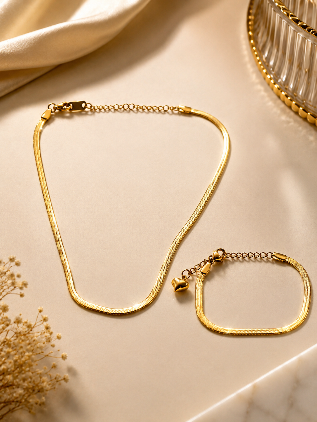 Serpentina Herringbone Duo Gold Plated Anti Tarnish Snake Chain Necklace & Bracelet set on a cream-colored surface