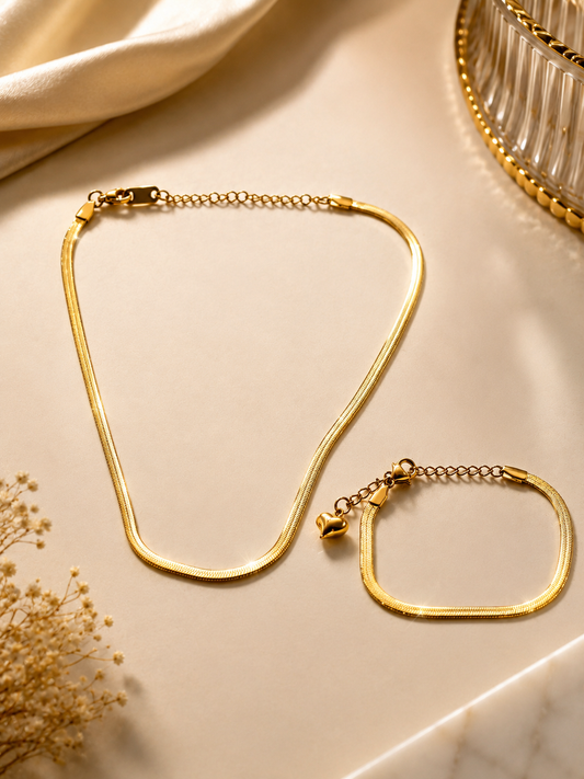 Serpentina Herringbone Duo Gold Plated Anti Tarnish Snake Chain Necklace & Bracelet set on a cream-colored surface