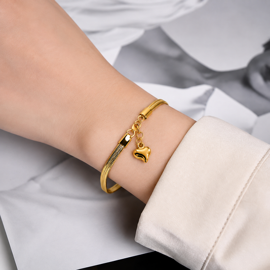 women wearing Serpentina Herringbone Gold Plated Anti Tarnish Snake Chain Heart Bracelet for Women