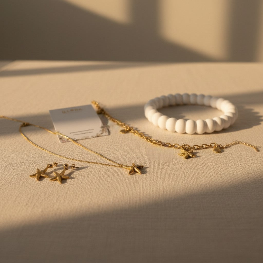 Starfish Necklace, Earrings & Charm Bracelet on a beige surface