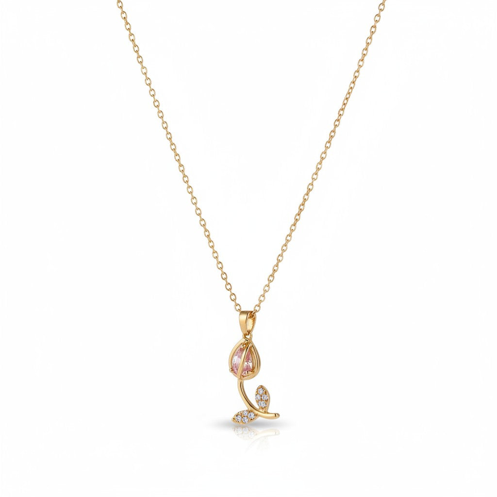 Close-up of anti-tarnish, gold plated Tulip necklace with a delicate pendant on a white background