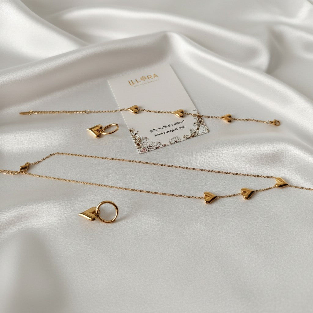 Gold-plated Heart Necklace, Heart Earrings & Heart Bracelet Set on a white satin surface