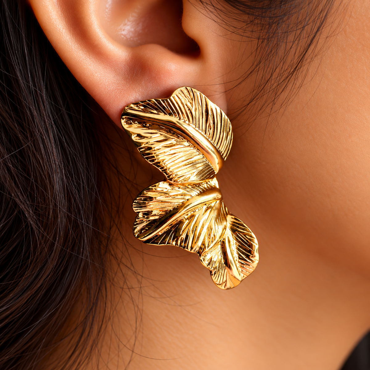 women wearing Gold Toned Chunky Three Leaf Stud Earrings for Women